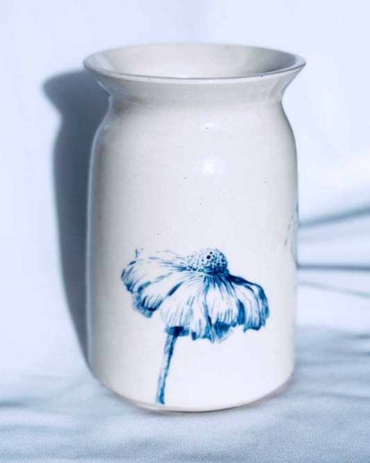 White ceramic vase with floral decoration on white background. 
