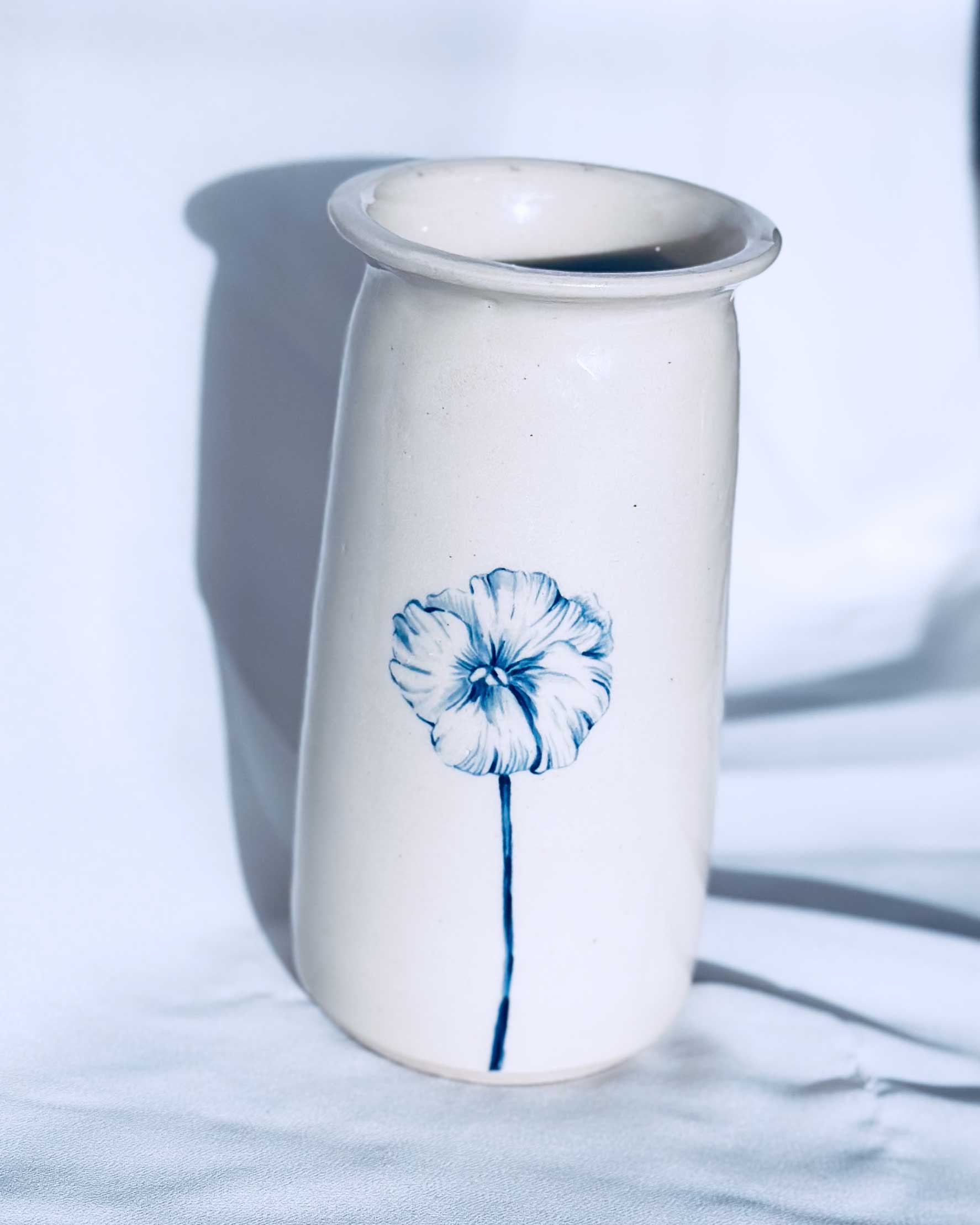 Illustrated floral ceramic vase on a white background